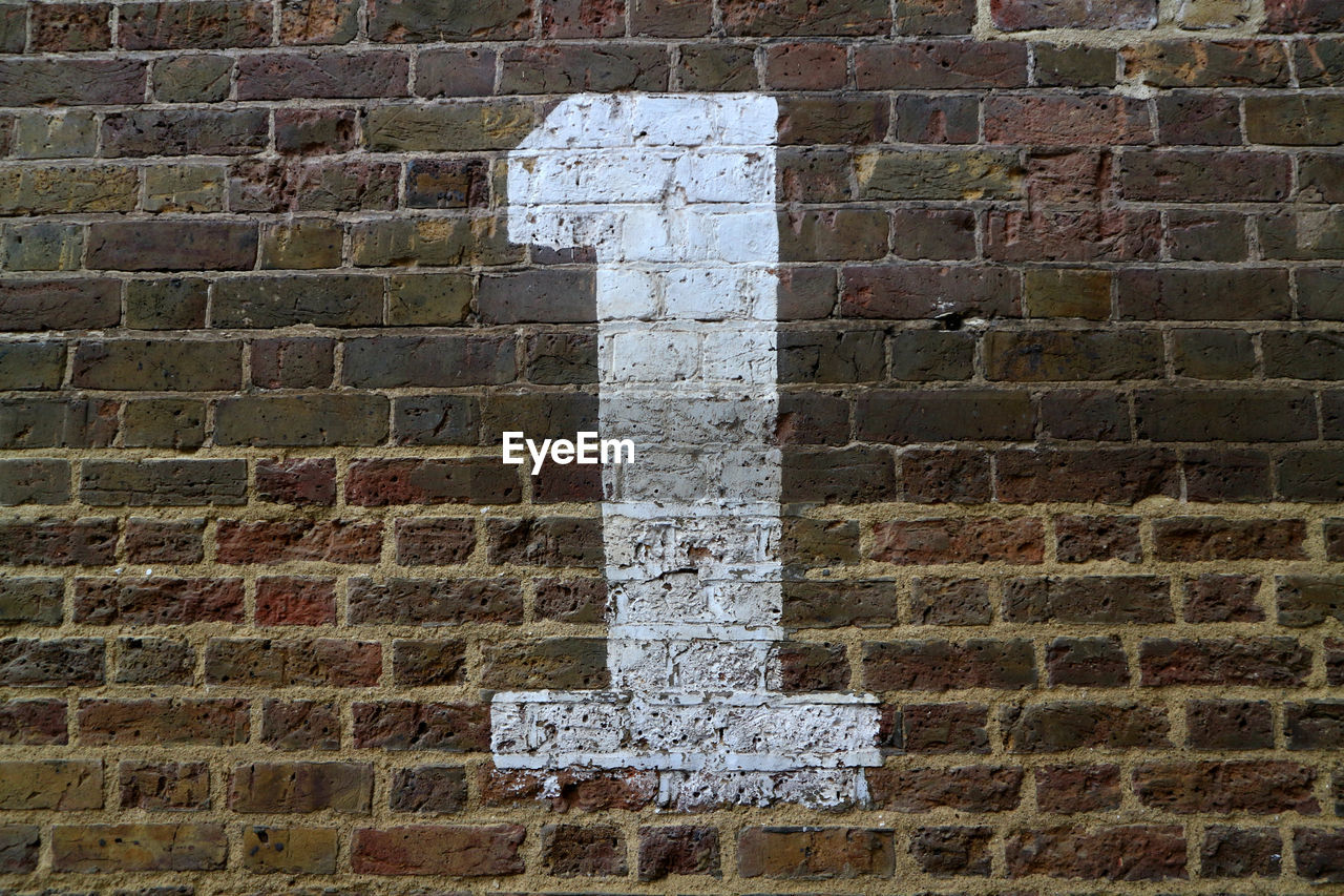 Close-up of number on brick wall