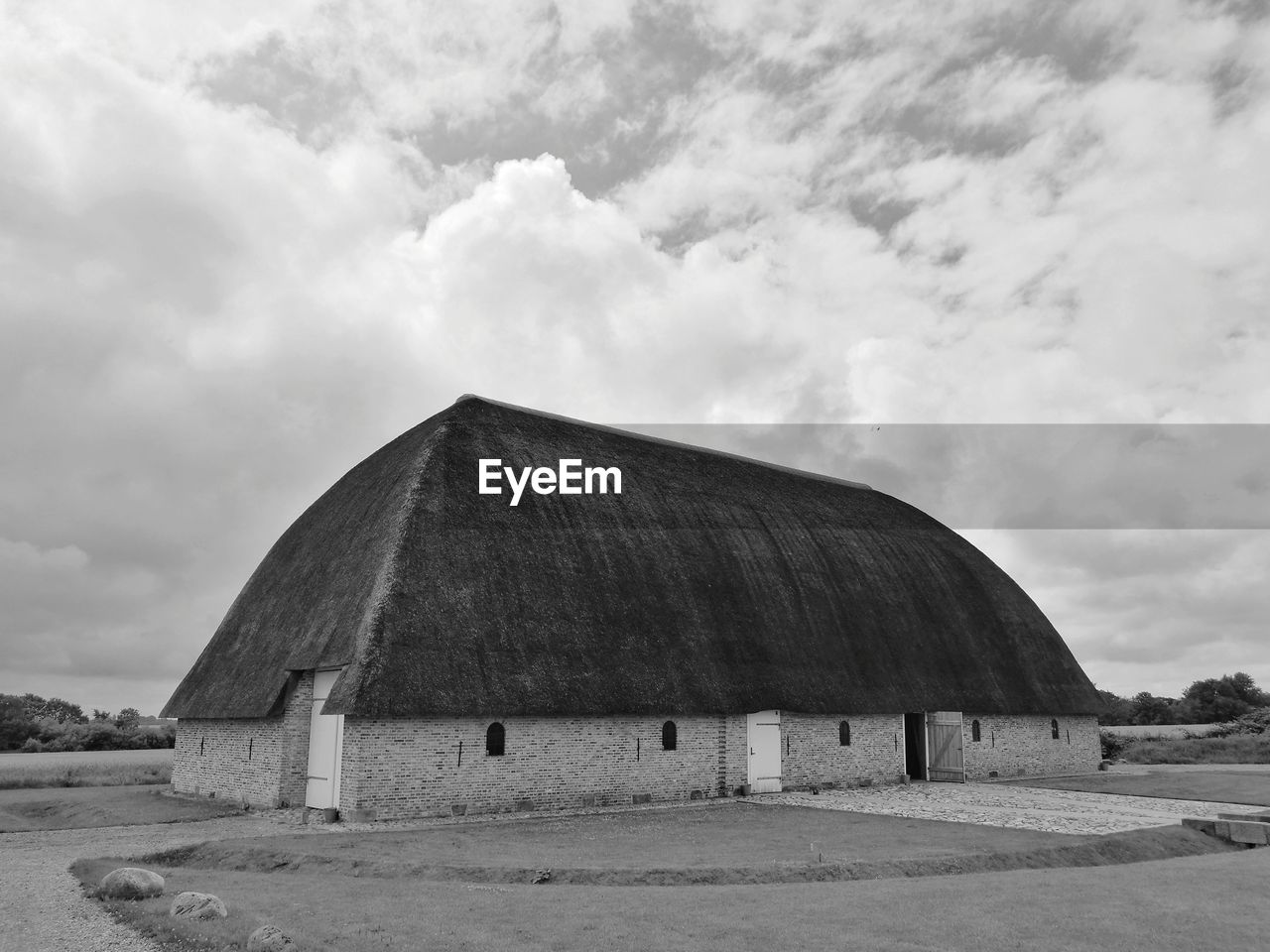 Barn on field against sky