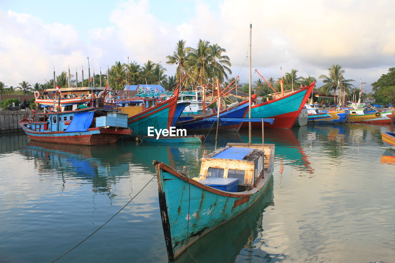 BOATS MOORED AT HARBOR