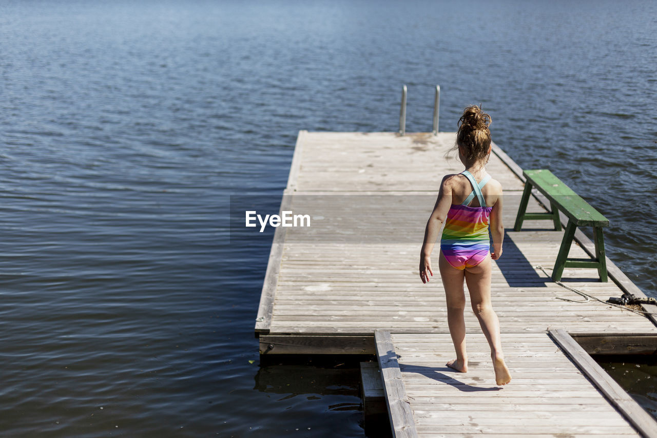 Rear view of girl on jetty