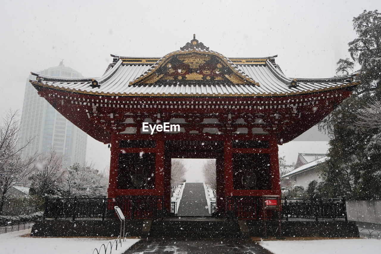 TRADITIONAL BUILDING COVERED WITH SNOW