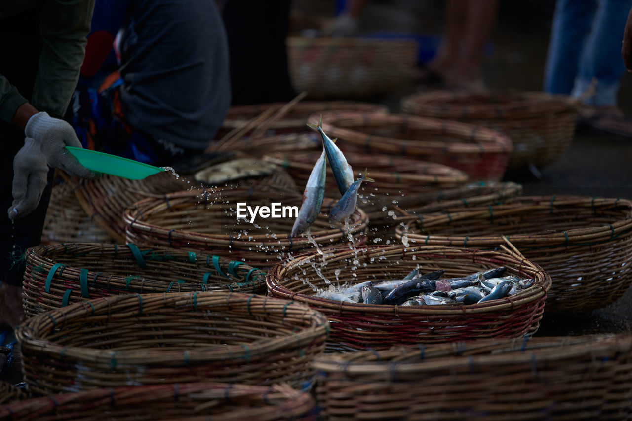 Buckets of fresh sardines fish at traditional seafood market, indonesia