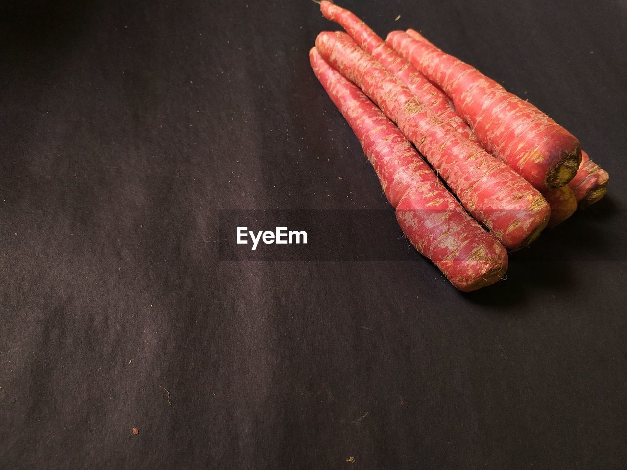 Closeup of healthy carrots with black background.