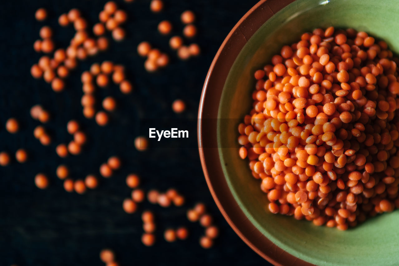 Orange lentils in bowl on table