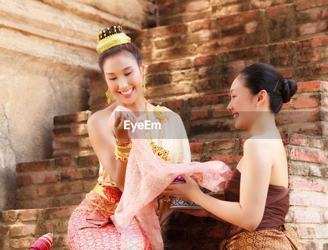 Young female models wearing traditional clothing at brick steps