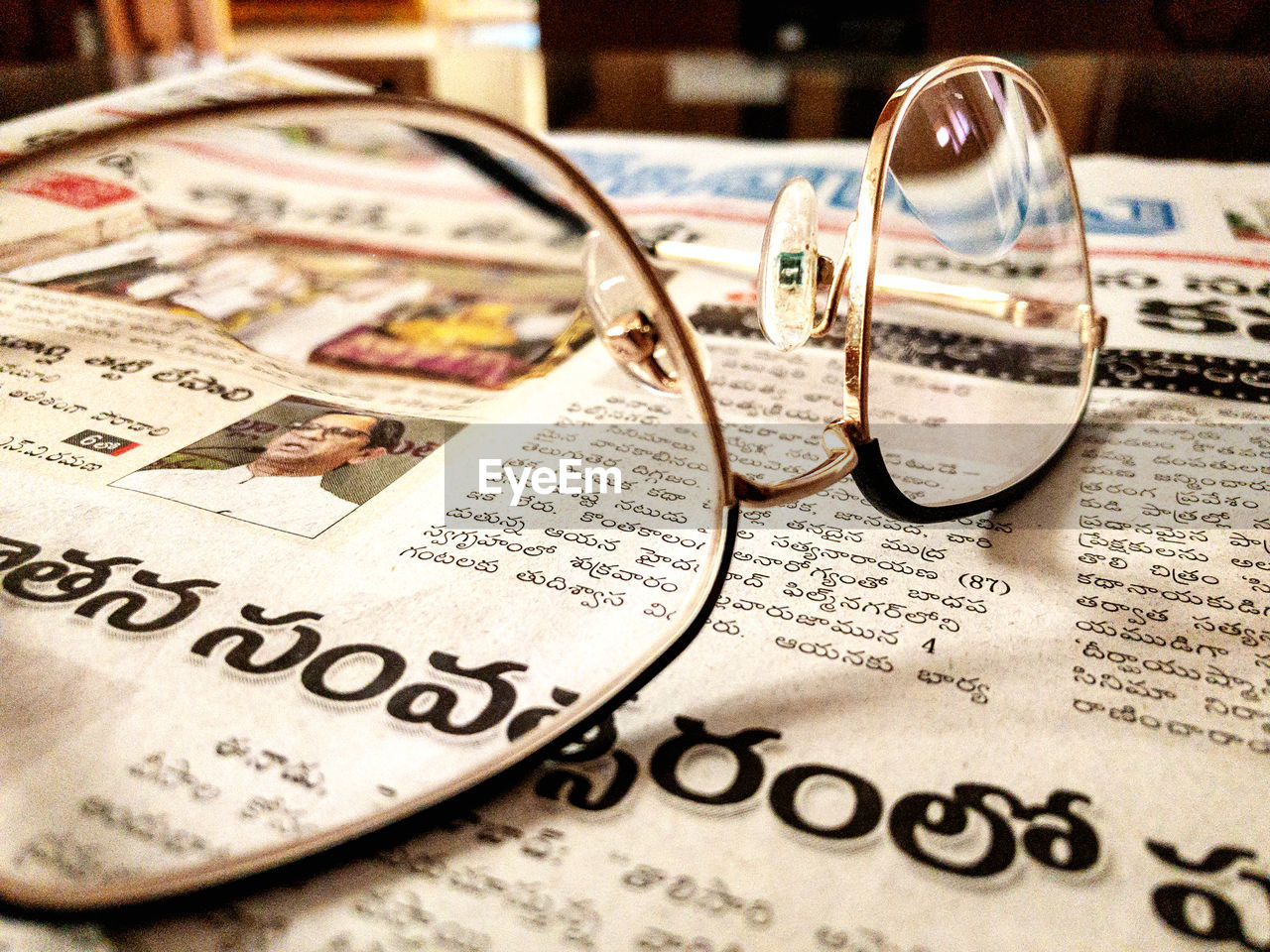 eyeglasses, glasses, newspaper, vision care, finance, paper, text, close-up, magnifying glass, business, no people, eyewear, wealth, indoors, still life, communication, currency