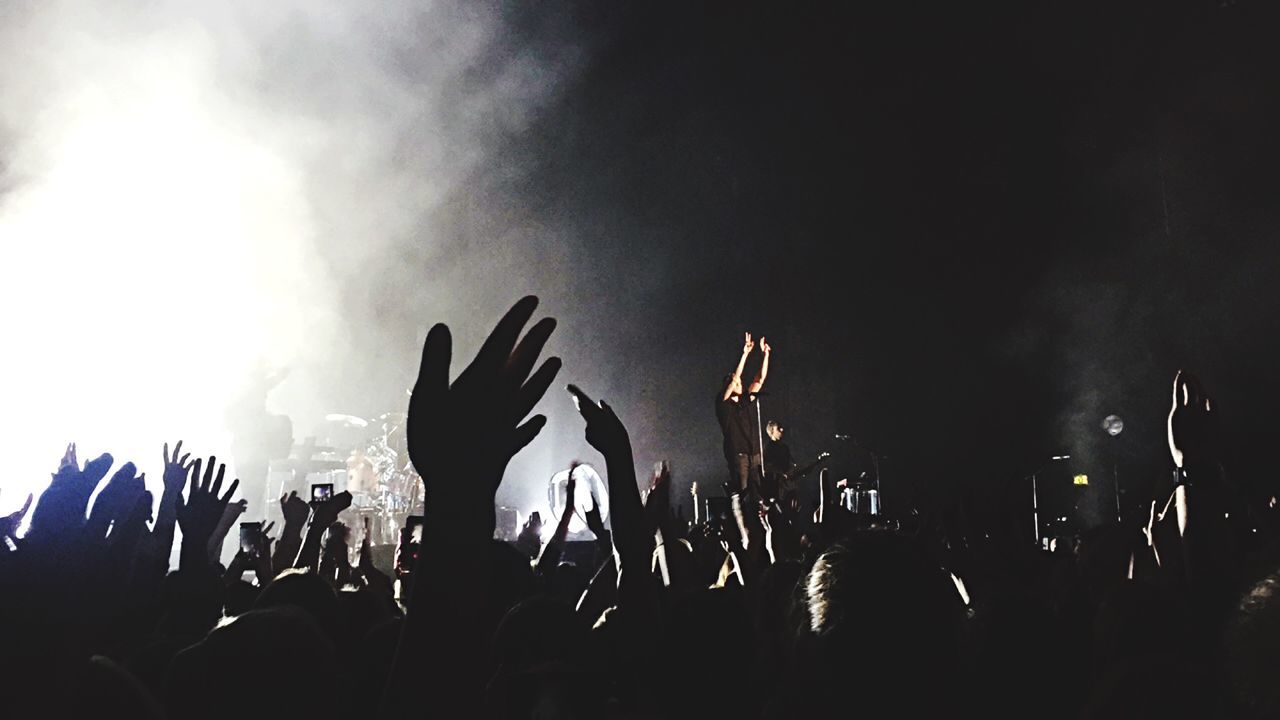 Crowd with hands raised at music festival