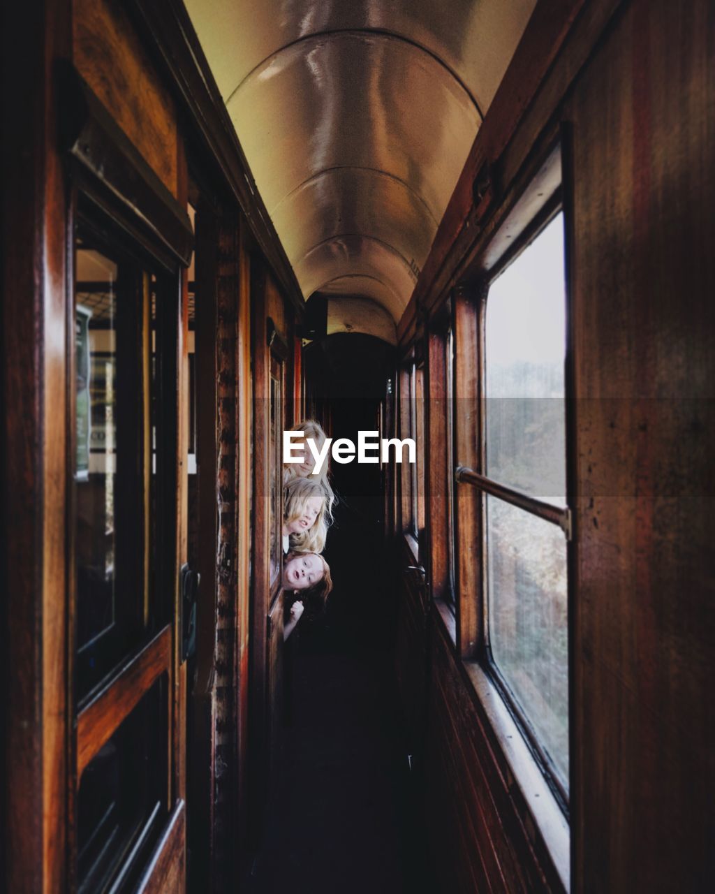 Sisters peeking through window while traveling in train