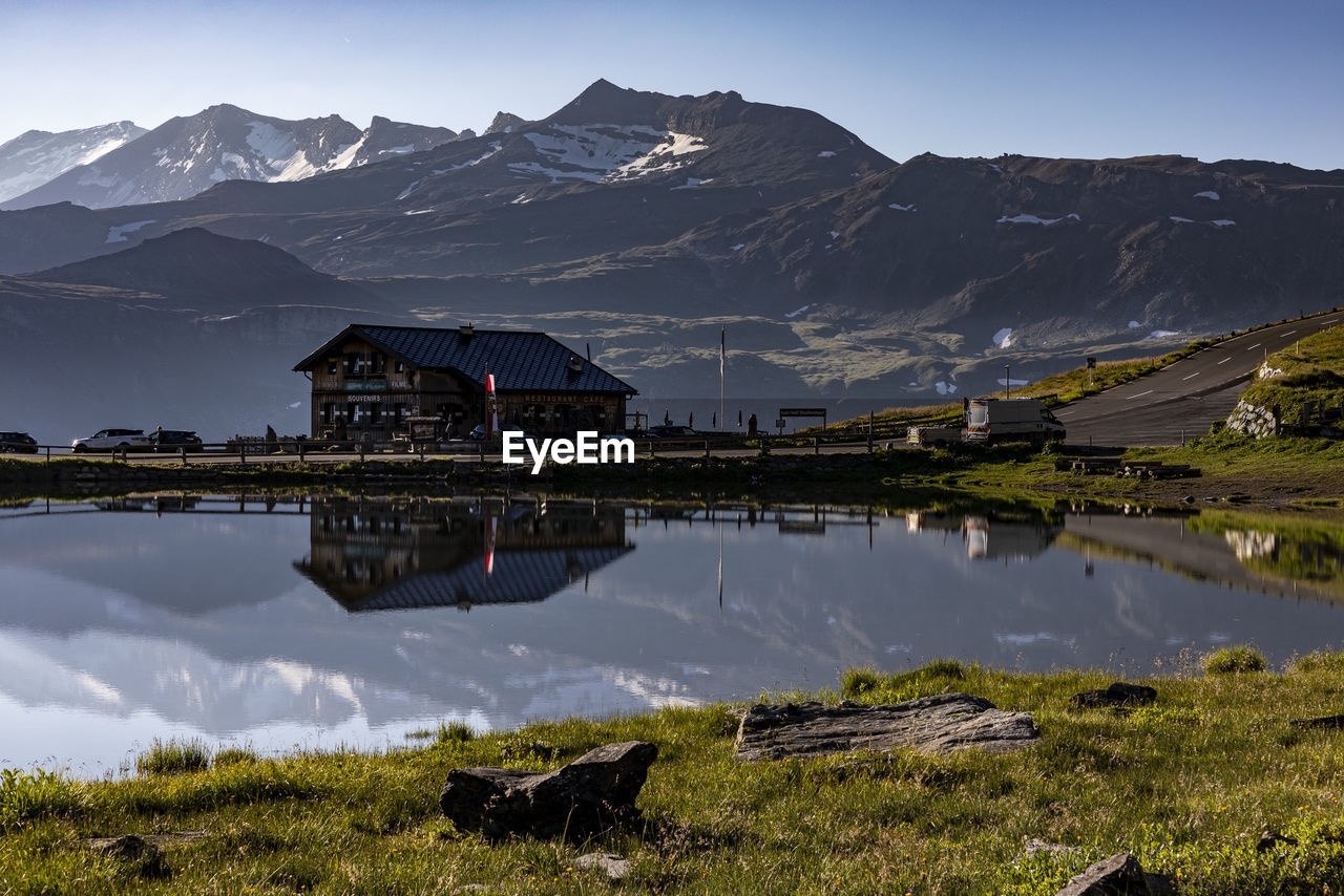 GAZEBO BY LAKE AND BUILDINGS AGAINST SKY