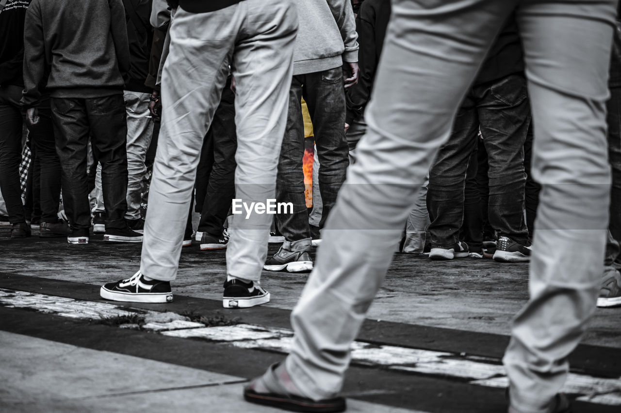 LOW SECTION OF MAN STANDING ON STREET