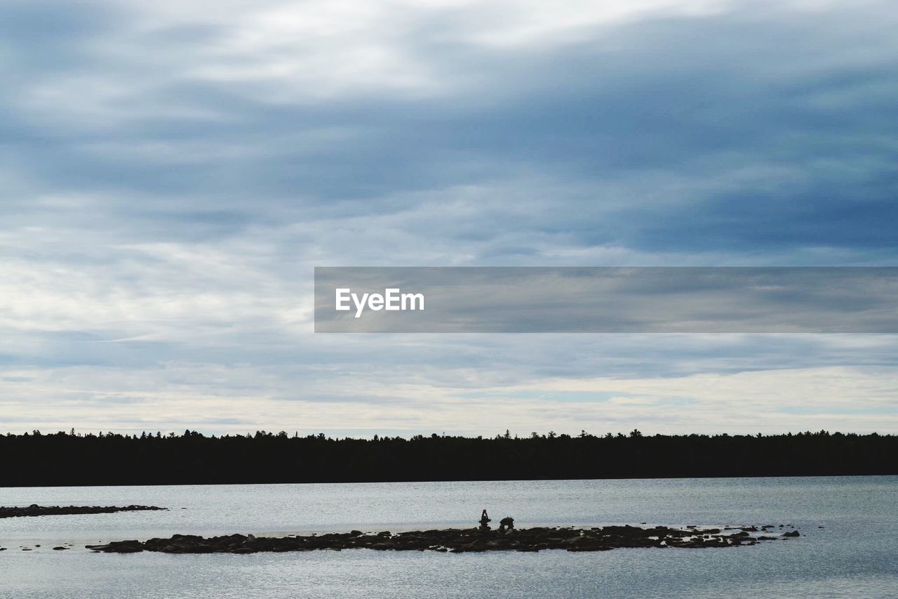 SCENIC SHOT OF CALM COUNTRYSIDE LAKE