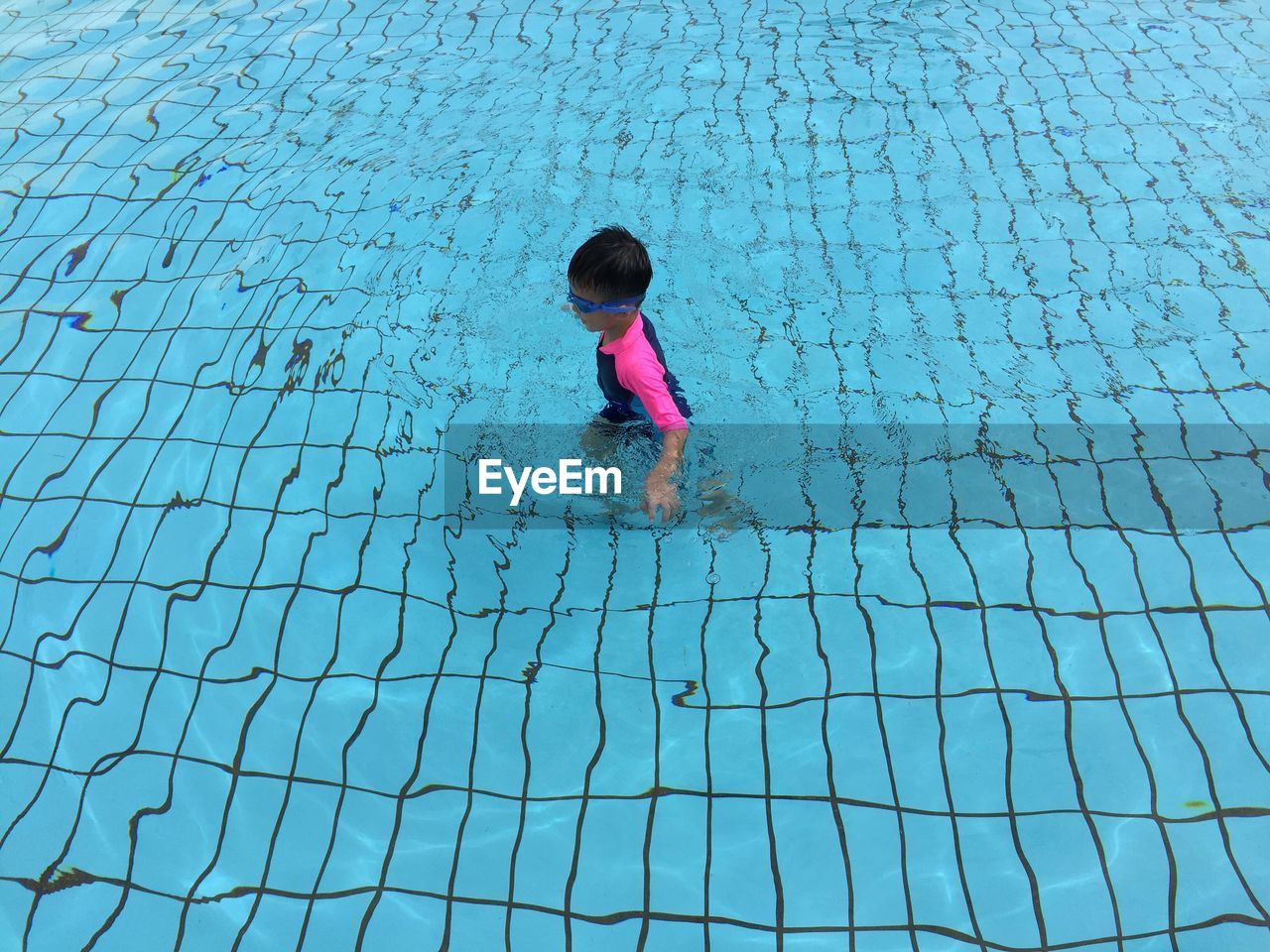 Full length of child in swimming pool