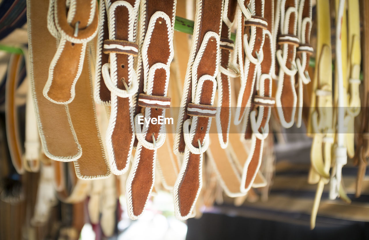 Close-up of belts hanging for sale in store