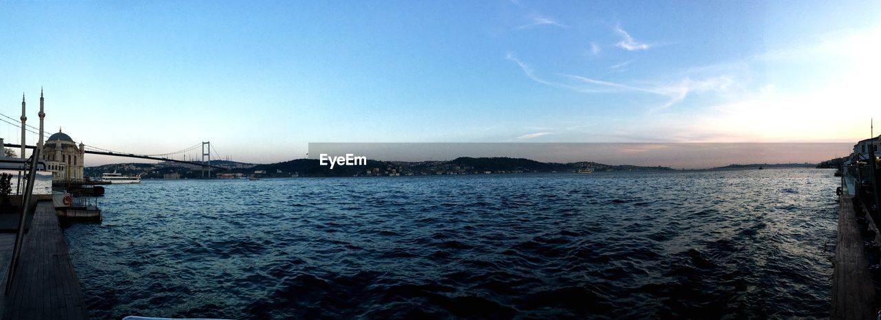 Bosphorus bridge over strait against sky