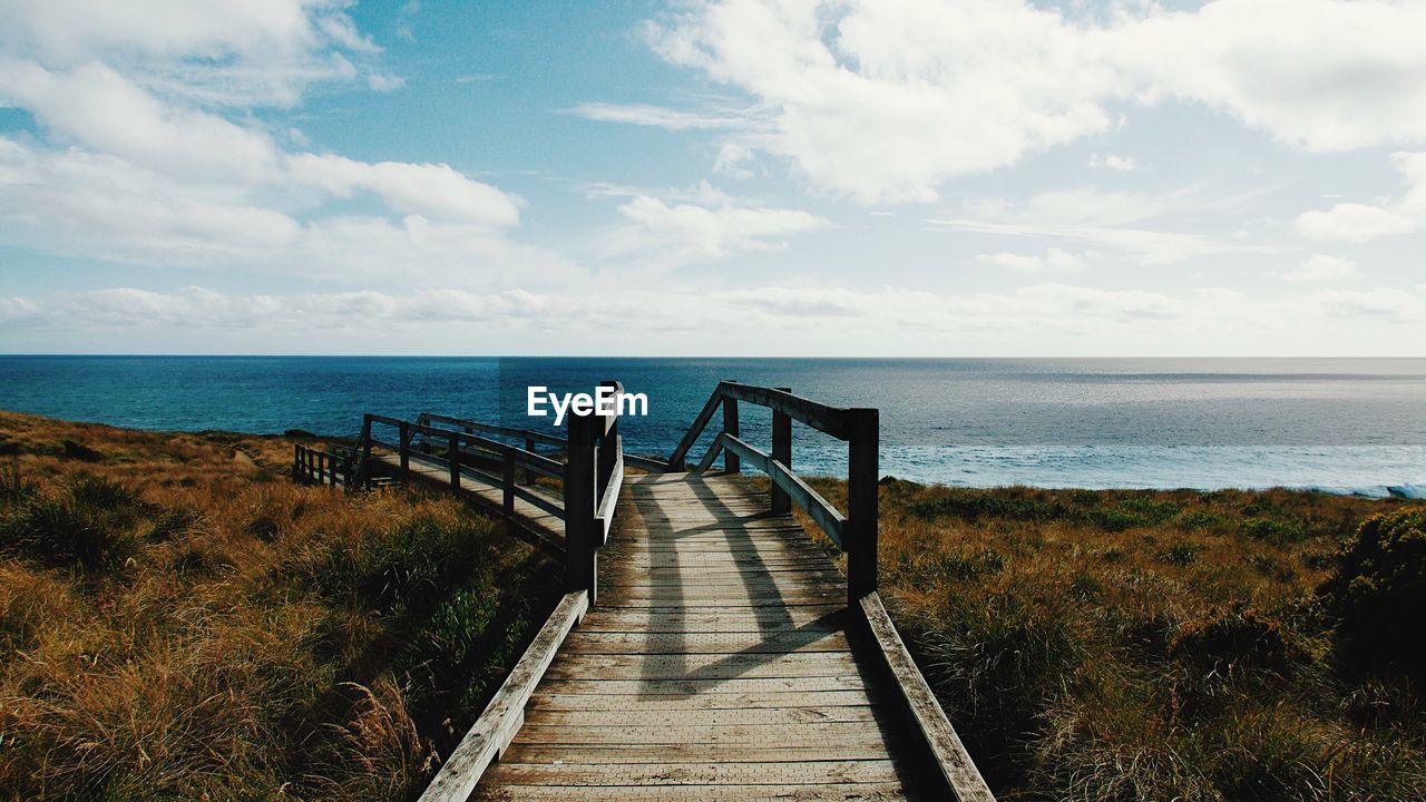 Pier over sea against sky