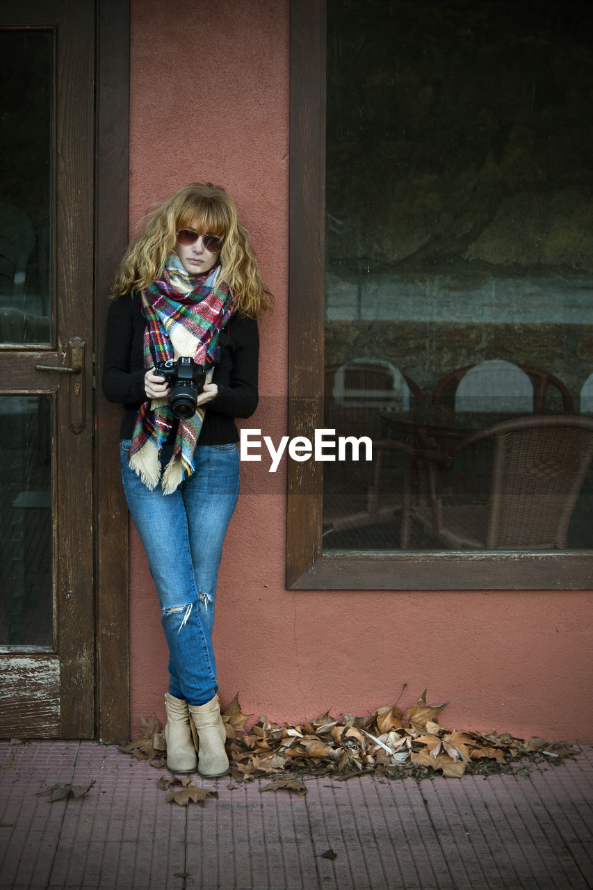 Woman with photo camera outdoors