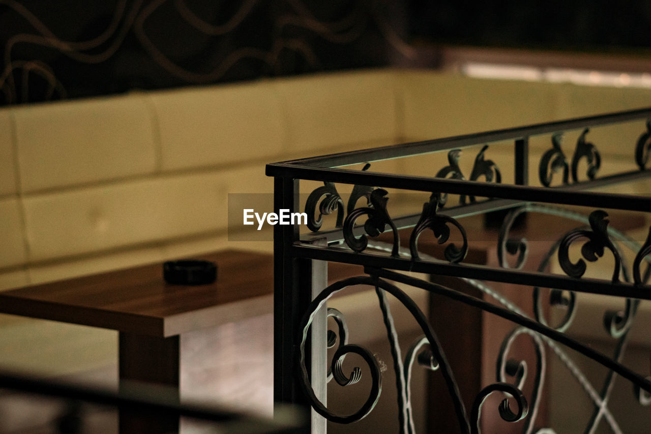 Close-up of railing against table at home