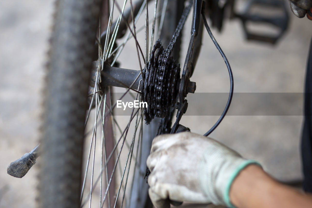 Close-up of hand holding bicycle