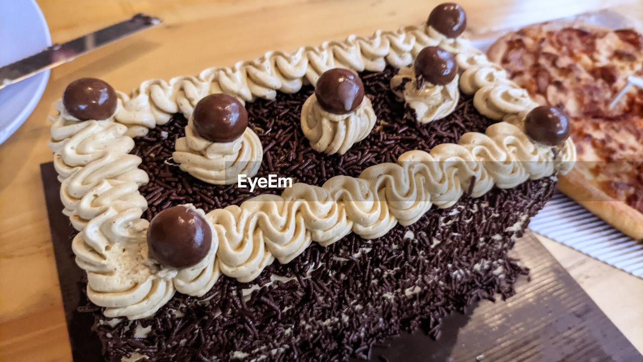 Close-up of birthday cake on wood table