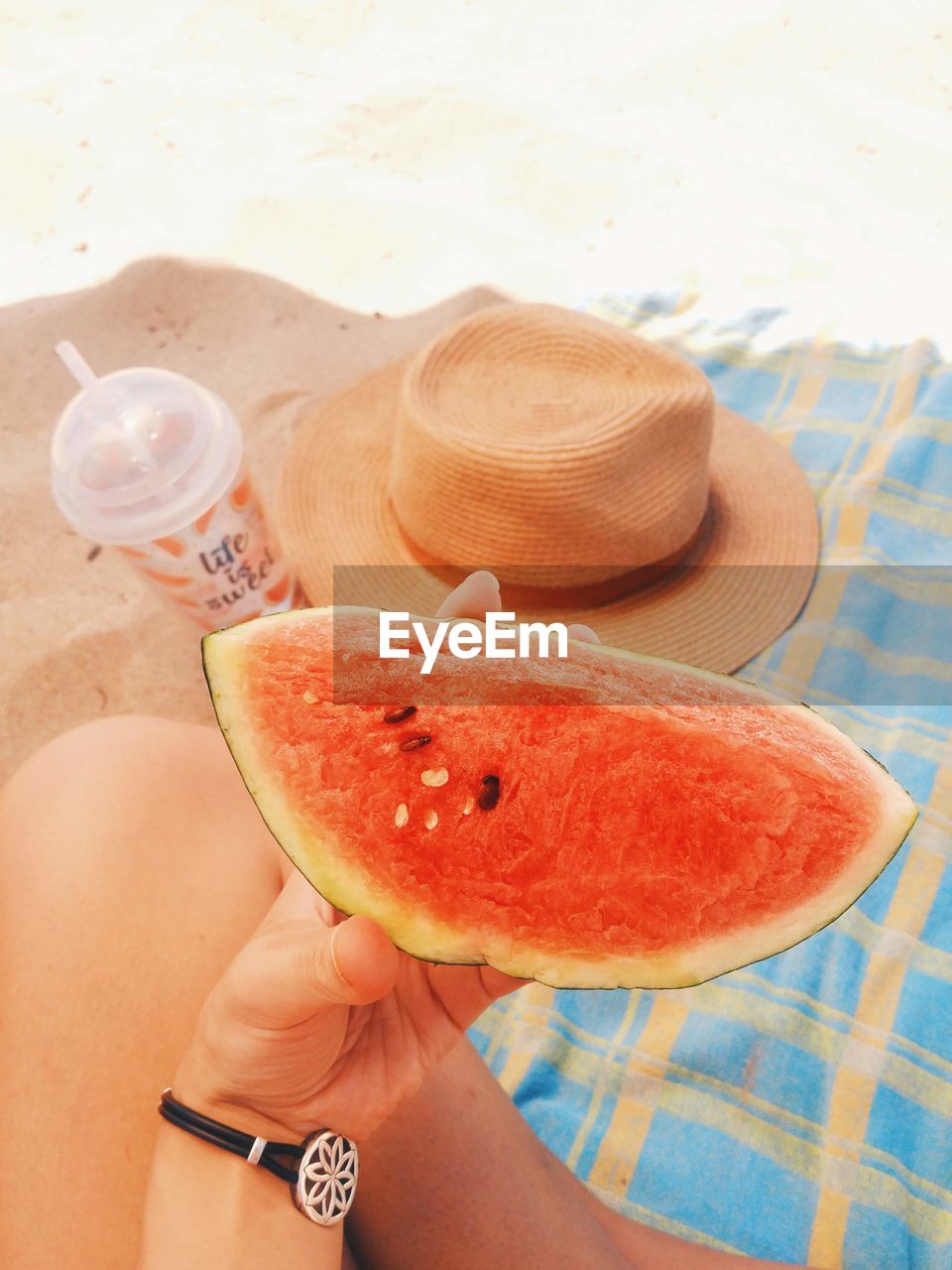 Cropped image of woman holding watermelon