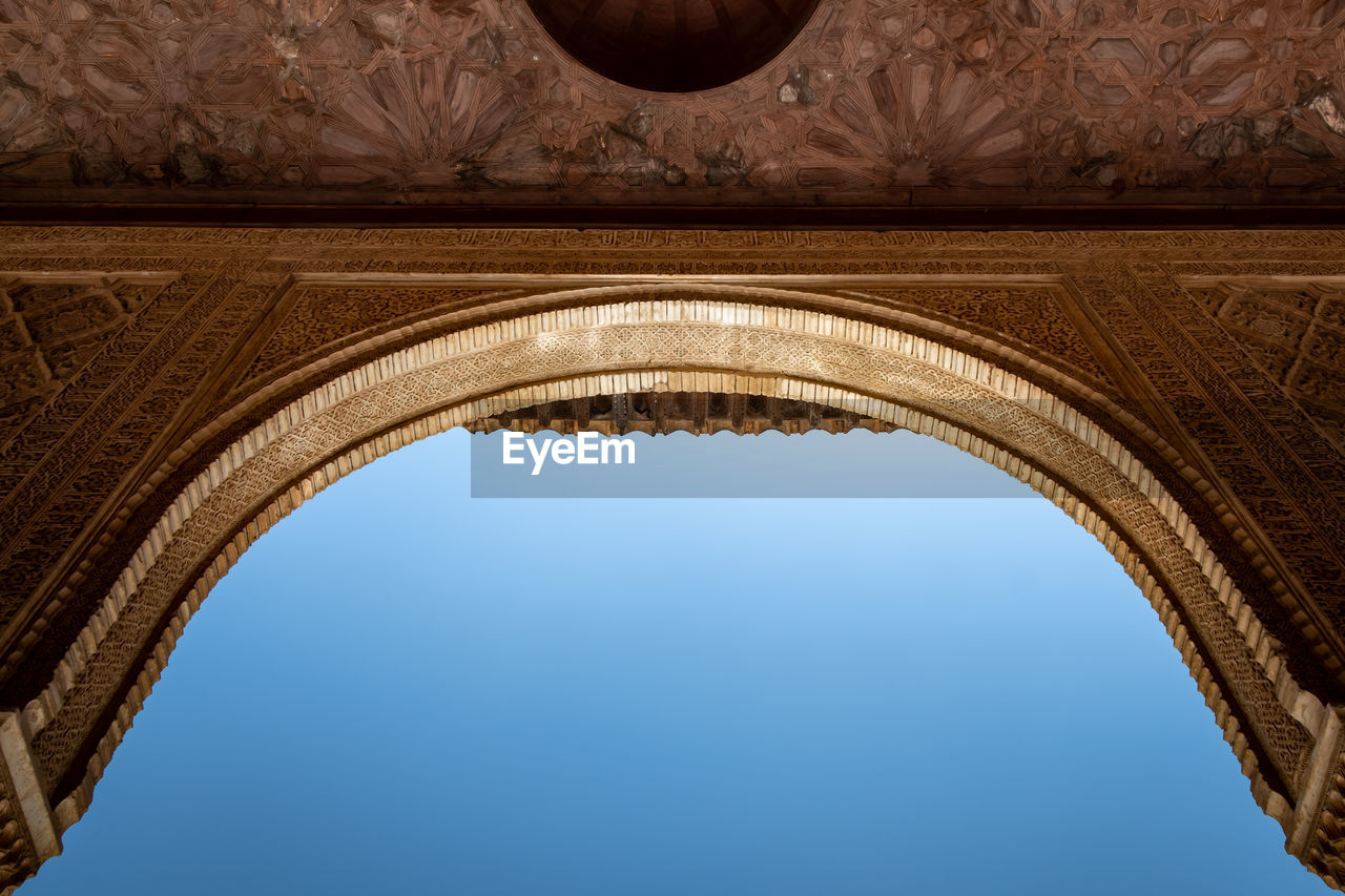 Low angle view of historical building against clear blue sky