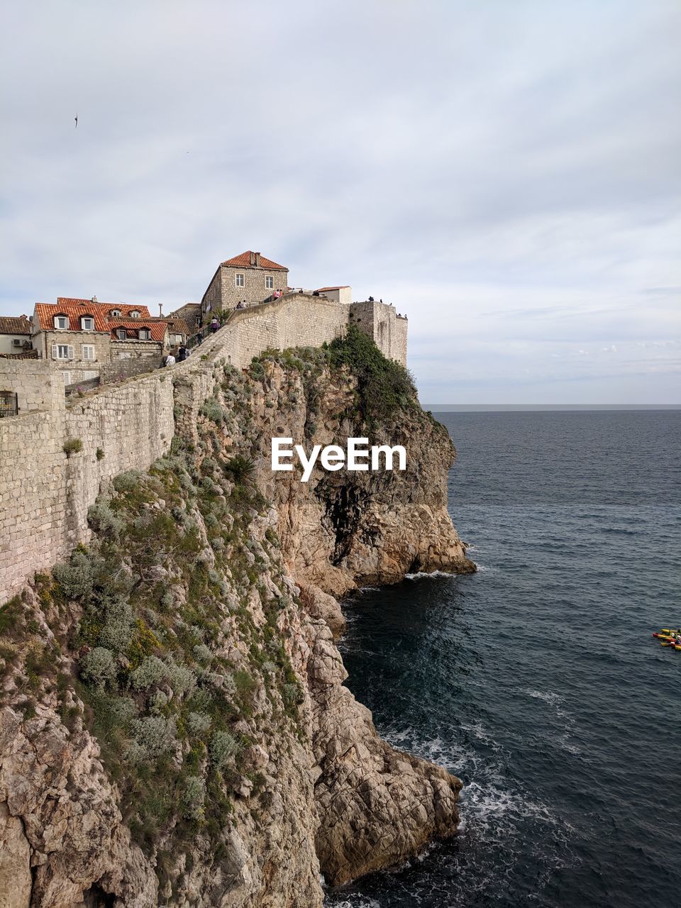 Historic building by sea against sky