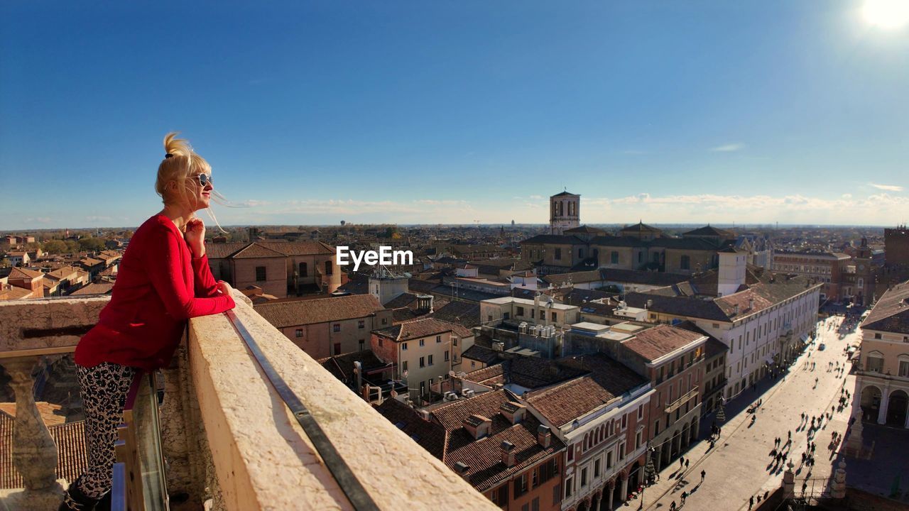 high angle view of woman standing against buildings in city