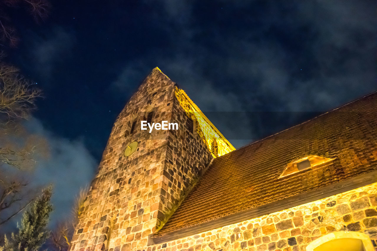 LOW ANGLE VIEW OF ILLUMINATED CASTLE AGAINST SKY