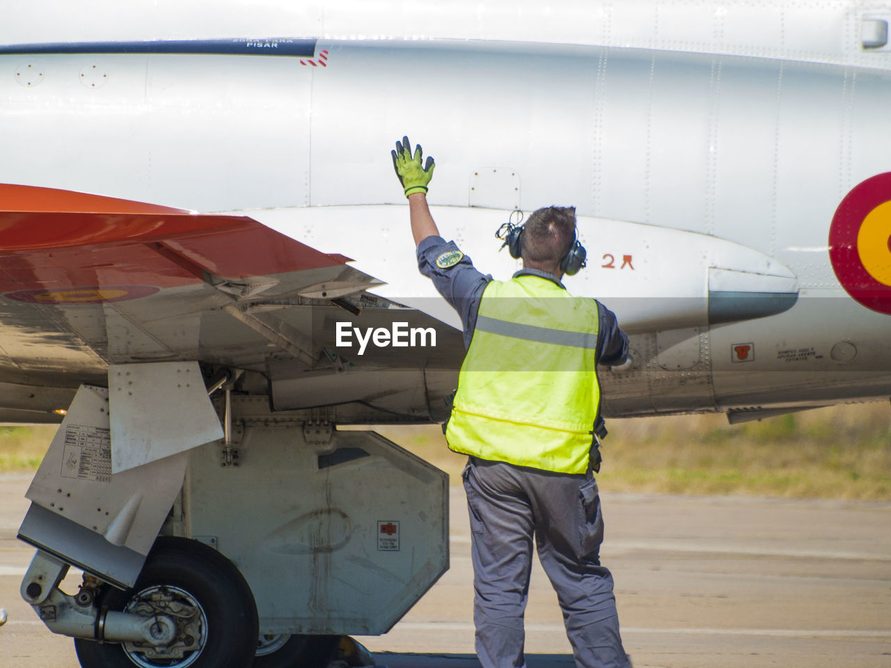 MAN WORKING ON AIRPLANE