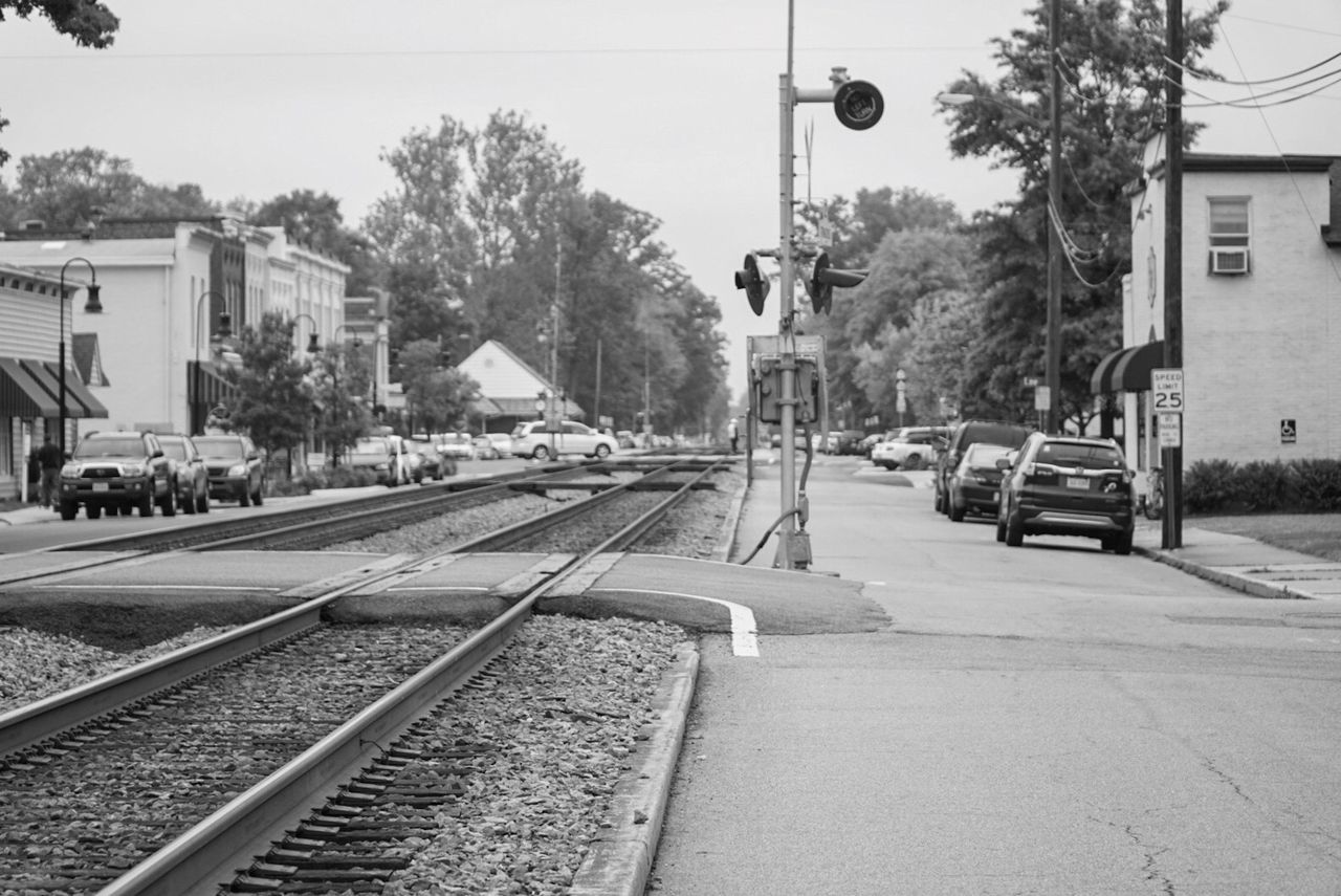 Railroad tracks by footpath in city