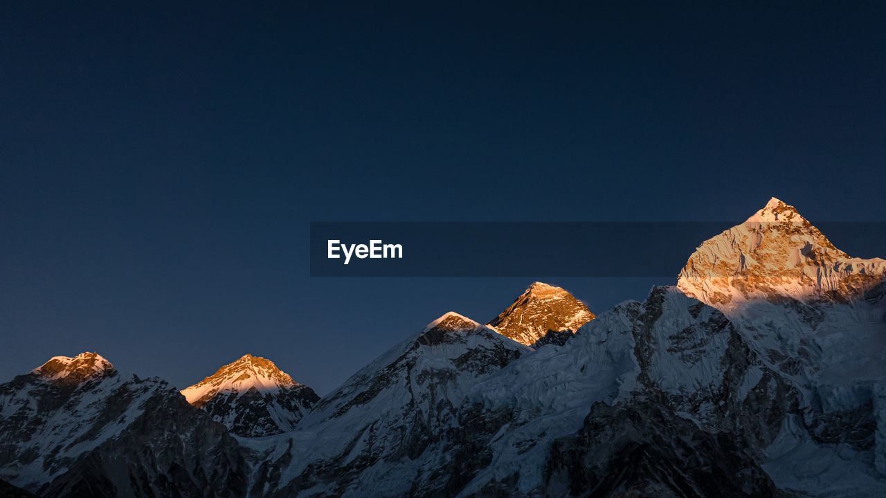 PANORAMIC VIEW OF SNOWCAPPED MOUNTAINS AGAINST CLEAR SKY