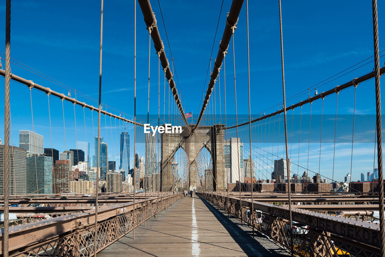 Brooklyn bridge against blue sky