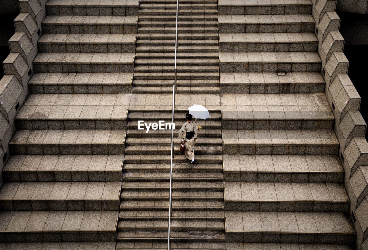 High angle view of woman walking on steps