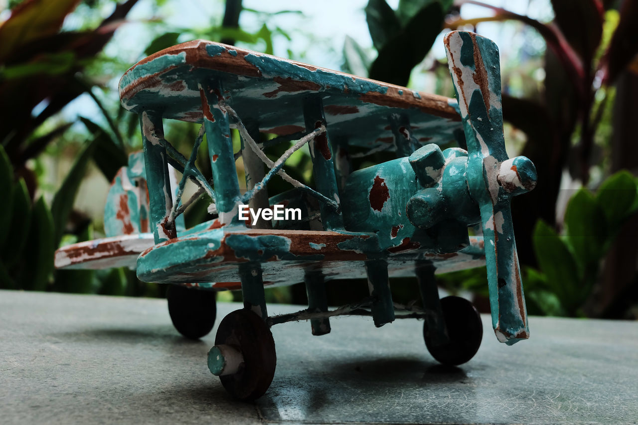Close-up of rusty wheel wooden airplane