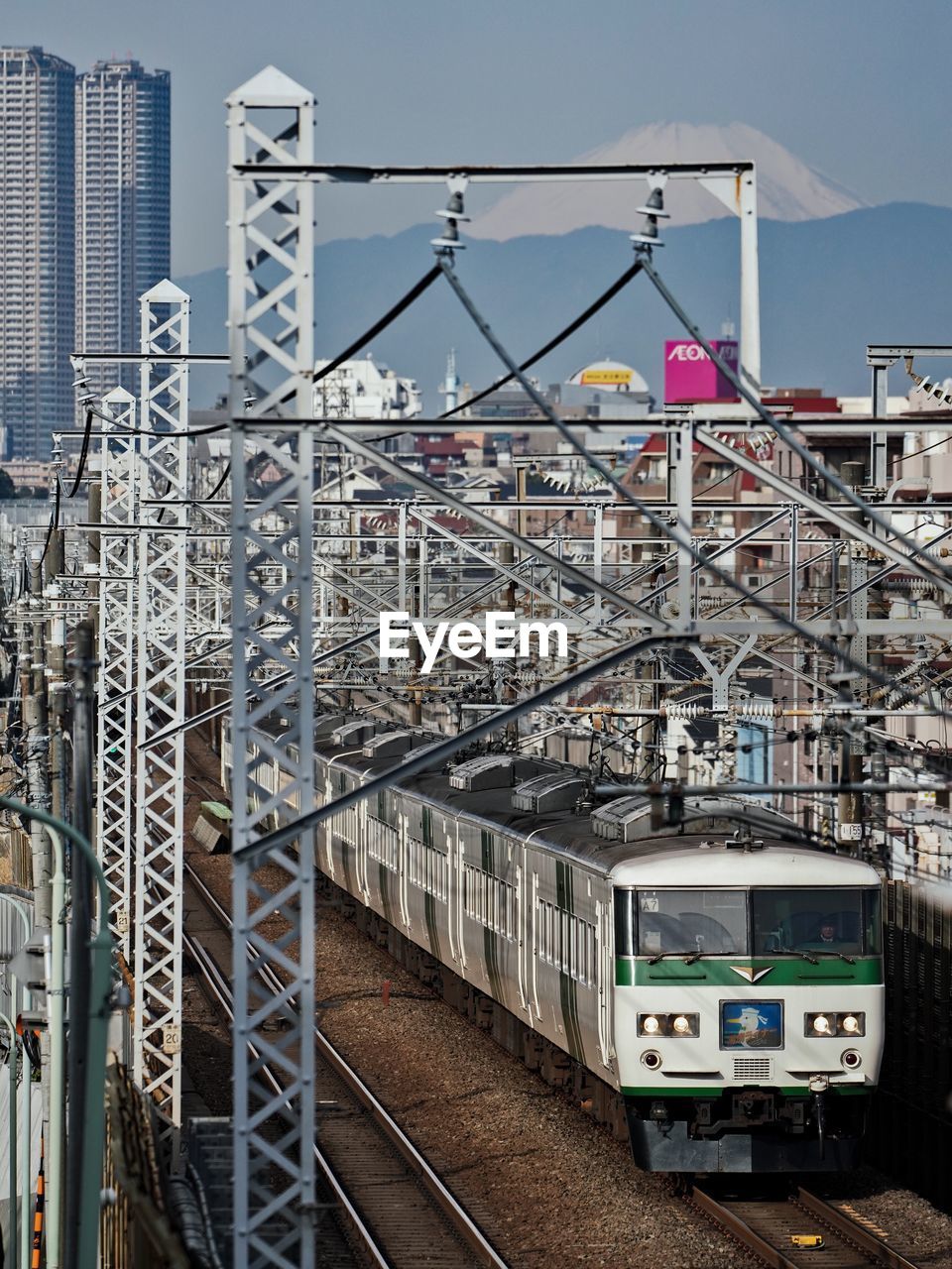TRAIN ON RAILROAD TRACKS AGAINST SKY