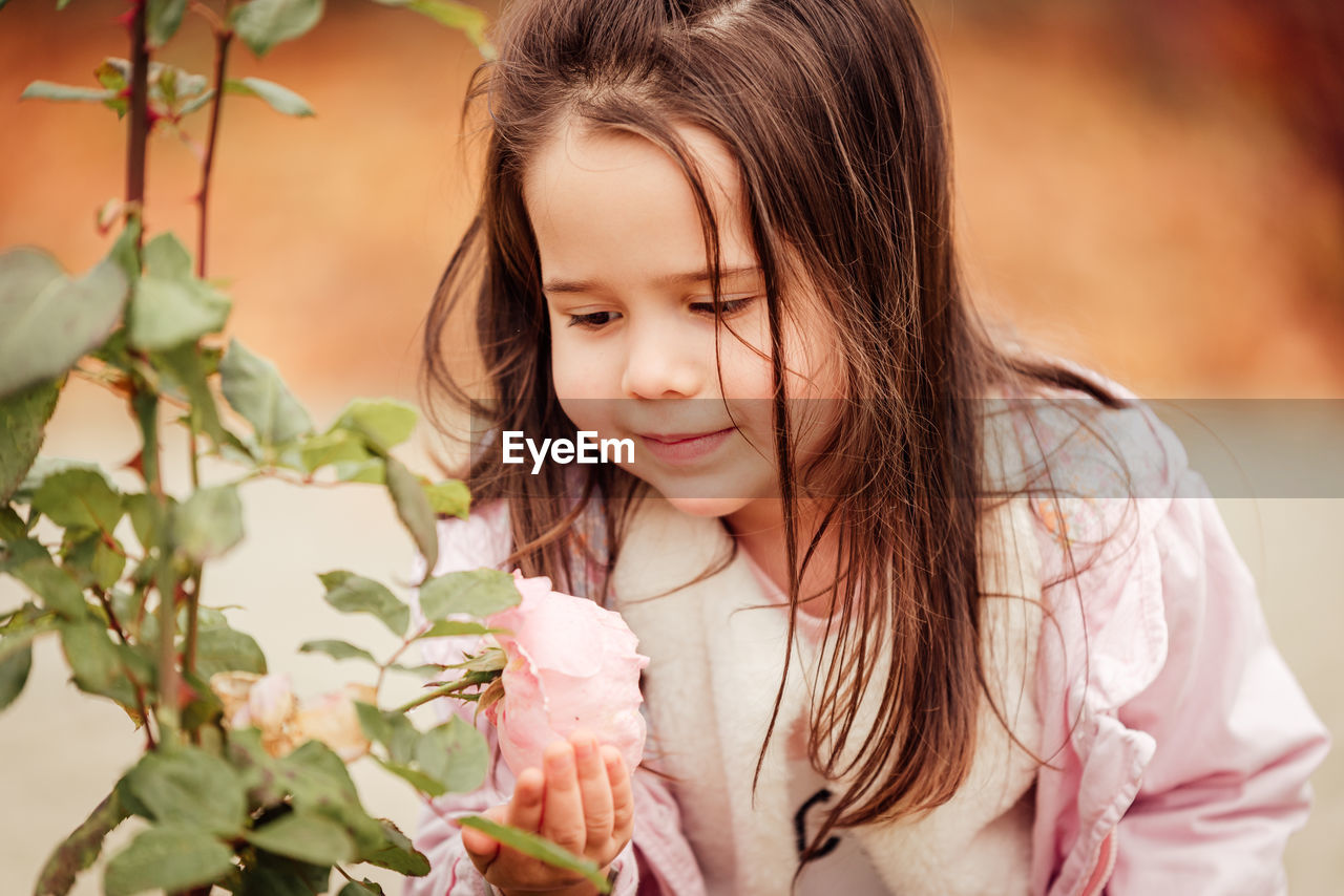 Close-up of cute girl with pink flowers