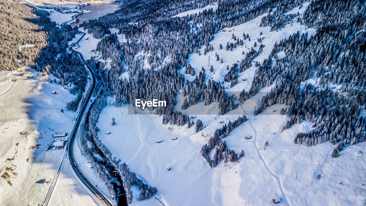 HIGH ANGLE VIEW OF SNOW COVERED LAND DURING WINTER