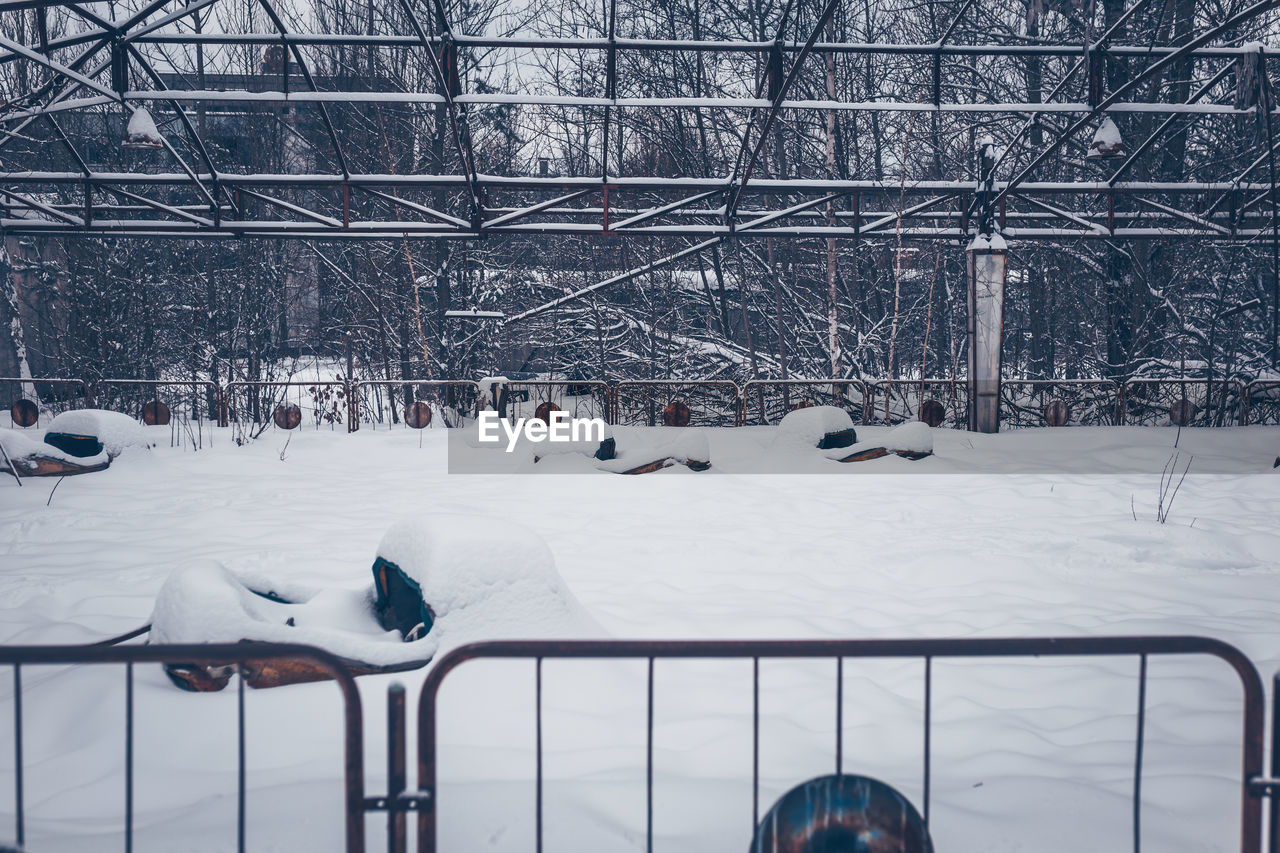 SNOW COVERED FIELD SEEN THROUGH WINDSHIELD OF BUILDING