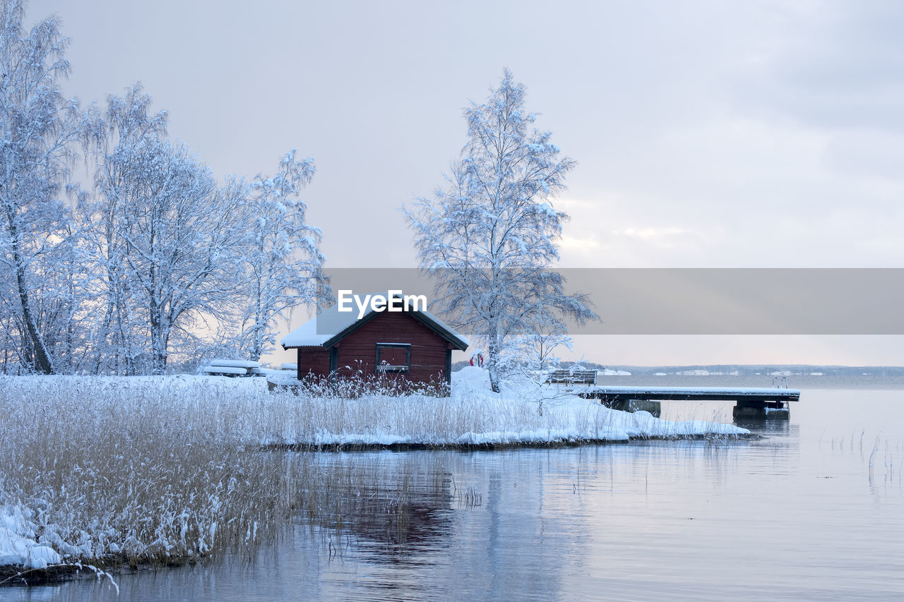Scenic view of lake against sky during winter