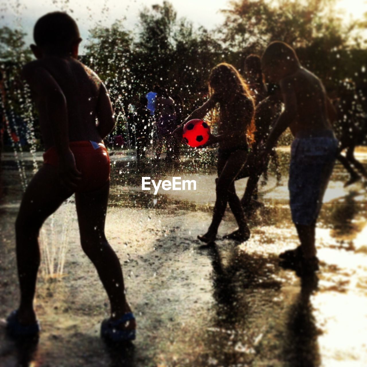 Kids playing in fountain at park