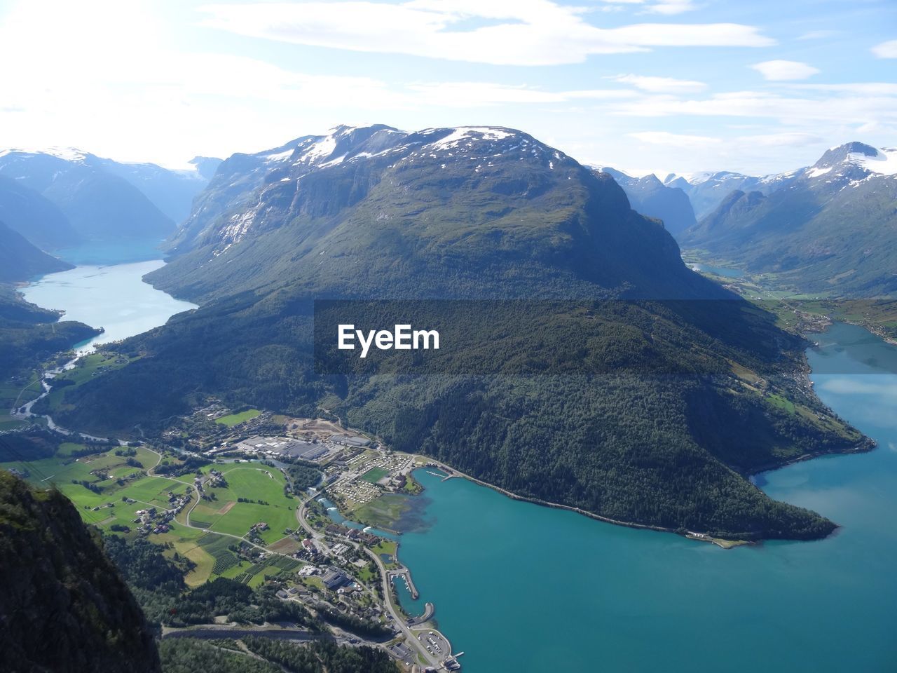 Scenic view of sea and mountains against sky