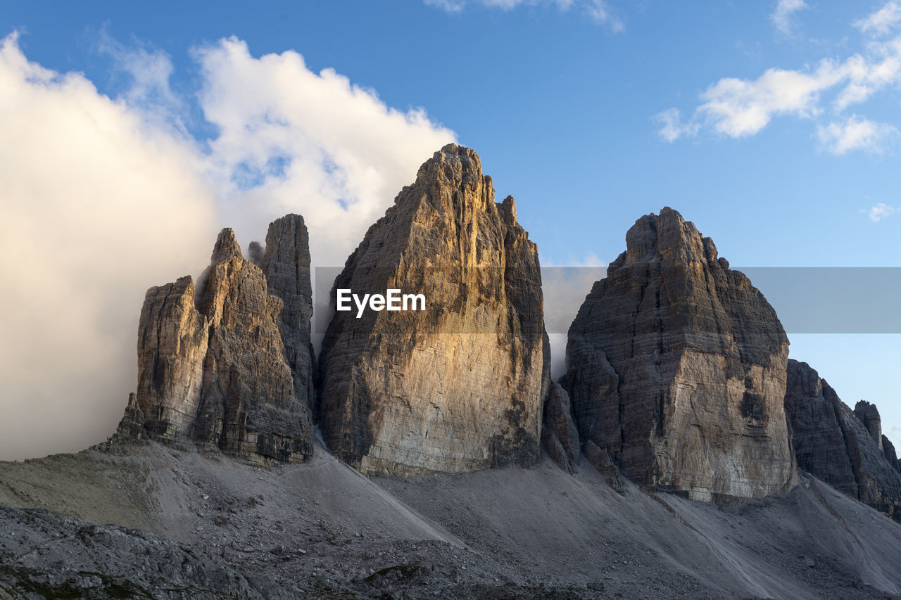 Low angle view of rocky mountains against sky