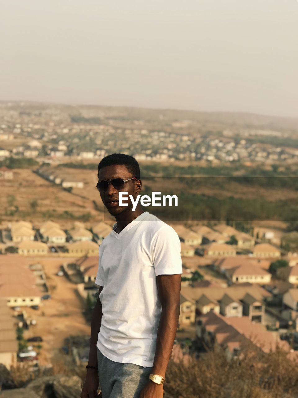 Portrait of young man standing on mountain