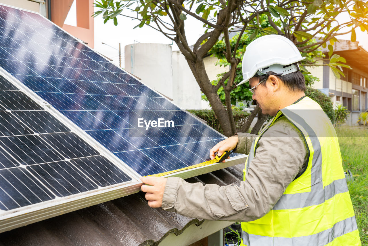 side view of man standing on solar