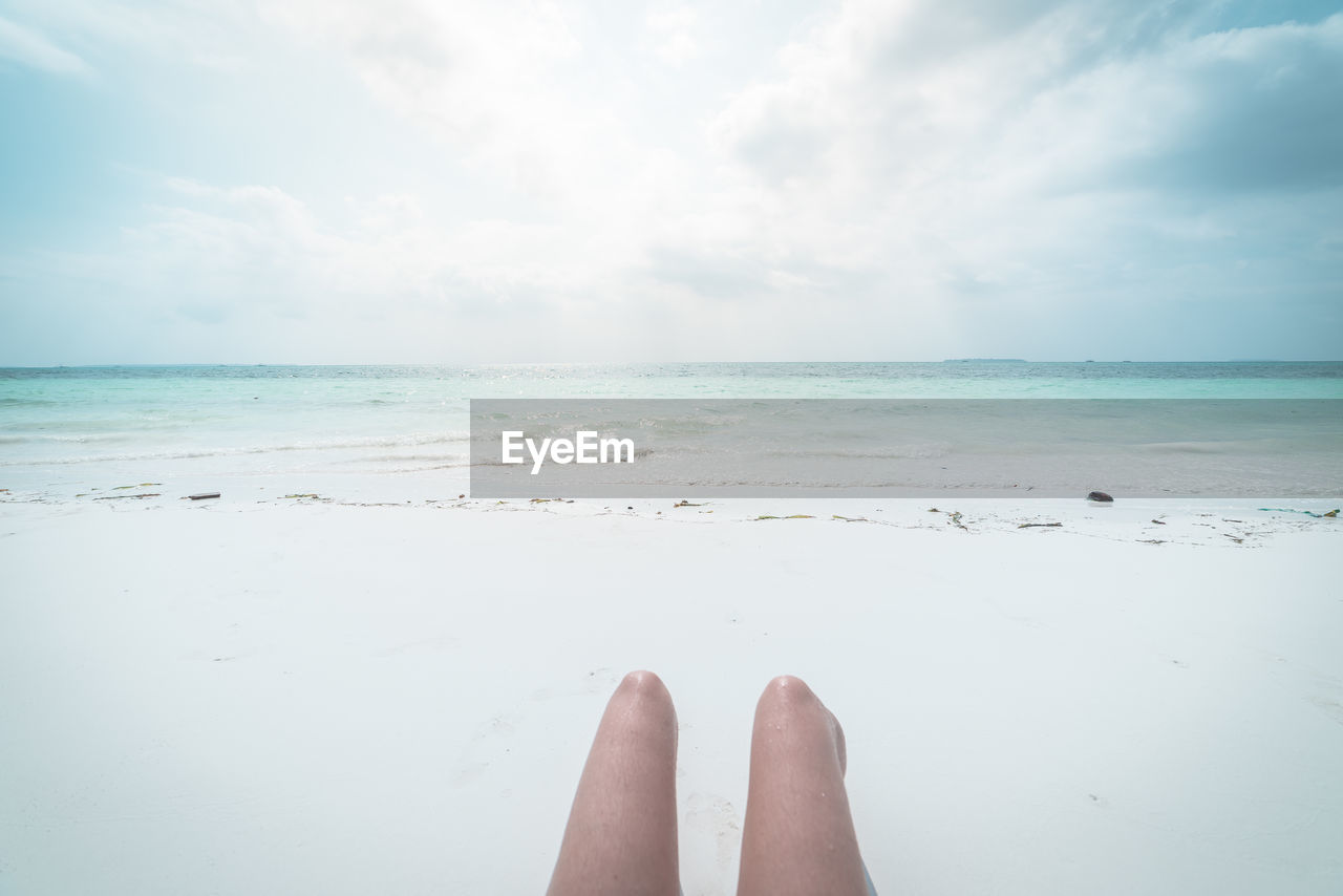 LOW SECTION OF PERSON ON BEACH