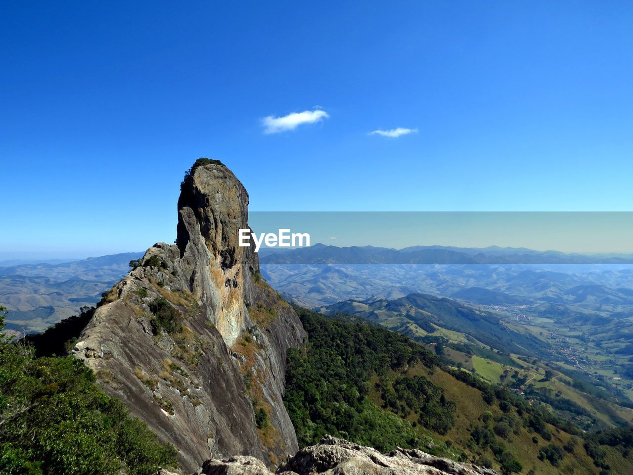 Scenic view of mountains against blue sky