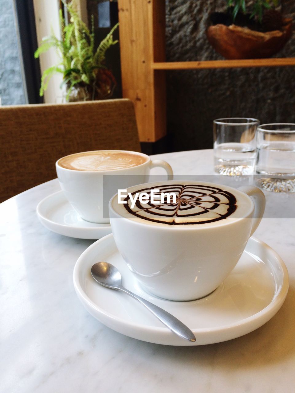 Close-up of coffee cups served on table