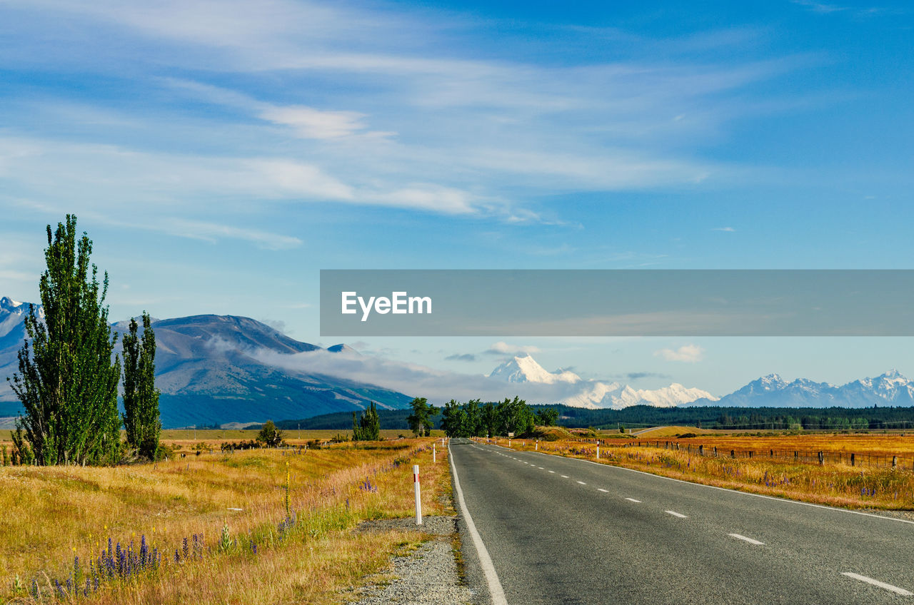 Empty road along countryside landscape