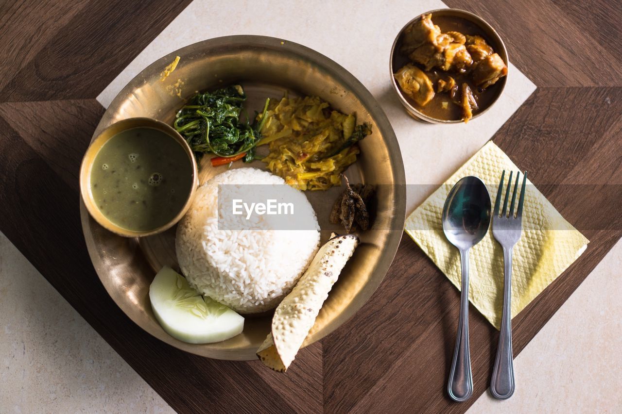 High angle view of dahl and rice served in plate on table