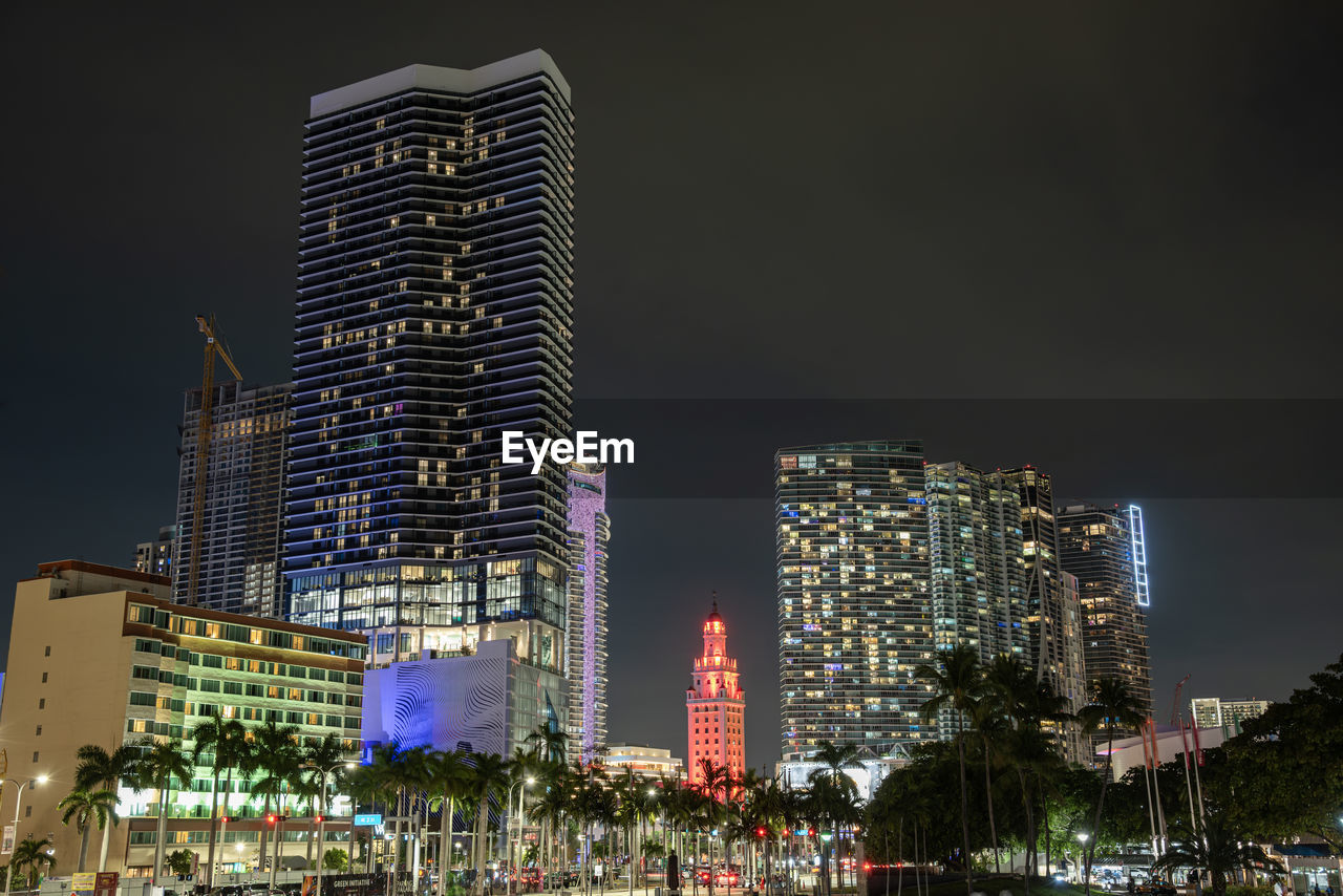 illuminated modern buildings in city at night